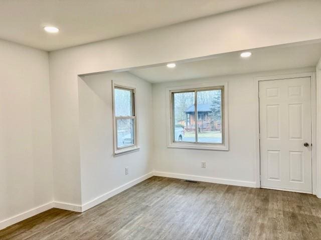 spare room with dark wood-type flooring