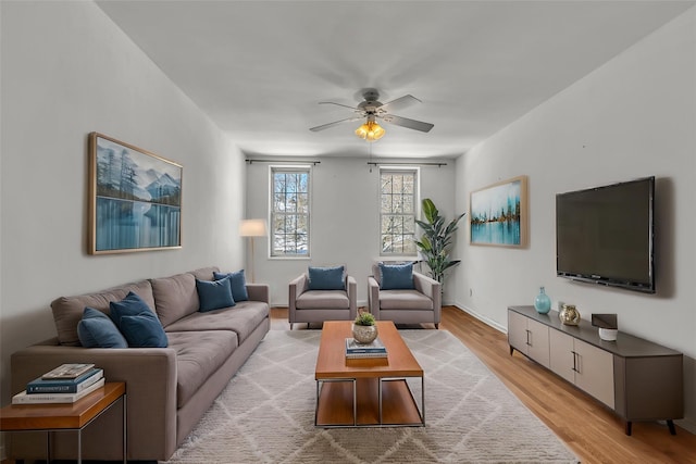 living room with light wood-type flooring and ceiling fan