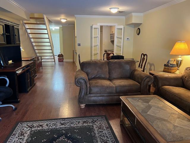 living room featuring crown molding and dark hardwood / wood-style floors