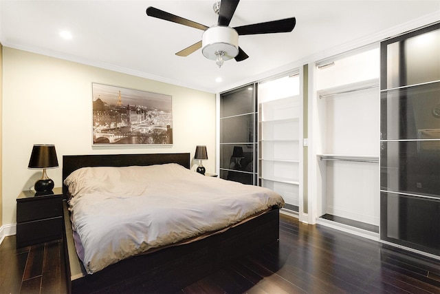 bedroom featuring ceiling fan, ornamental molding, and dark hardwood / wood-style floors