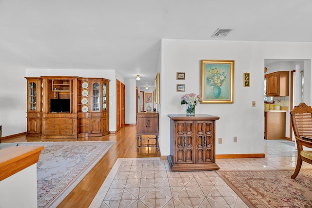 interior space with visible vents, baseboards, and light tile patterned flooring