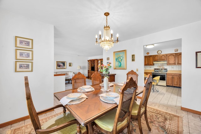 dining room featuring baseboards and an inviting chandelier