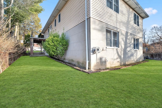 view of side of home featuring a yard