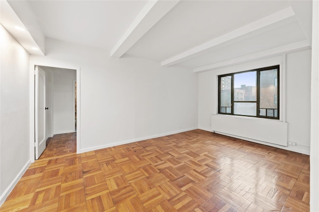 spare room with light parquet flooring and beam ceiling