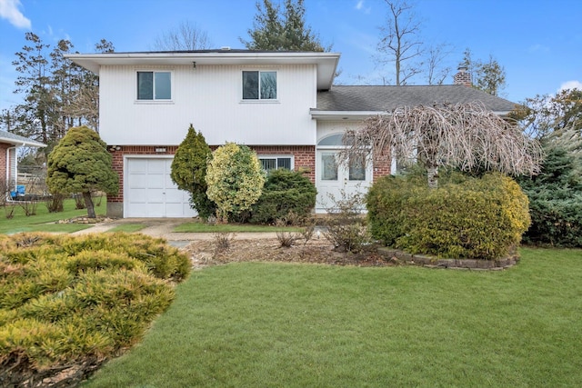 tri-level home with brick siding, a chimney, an attached garage, and a front lawn