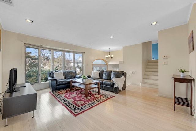 living area featuring visible vents, stairs, light wood-type flooring, a notable chandelier, and recessed lighting