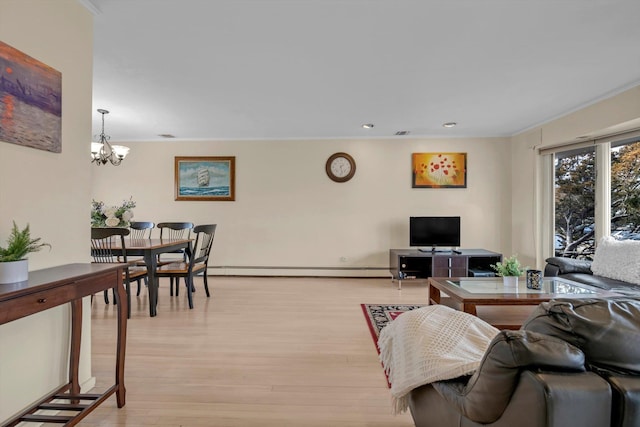 living area with light wood finished floors, a chandelier, baseboard heating, and ornamental molding