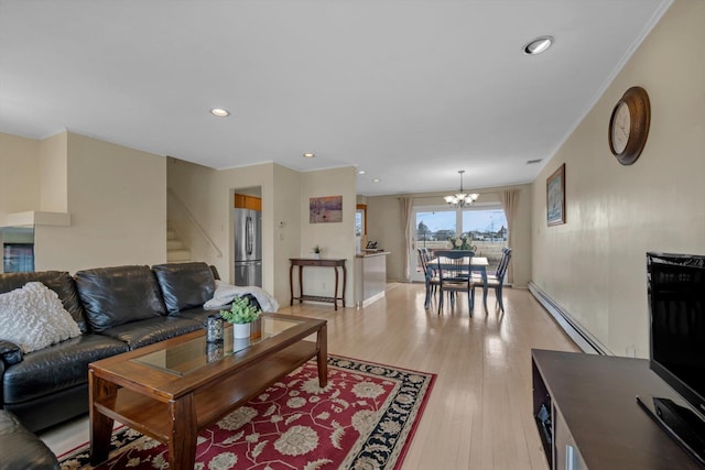 living area featuring a notable chandelier, a baseboard radiator, recessed lighting, light wood-style flooring, and stairs