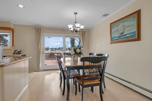 dining area with a notable chandelier, a baseboard heating unit, visible vents, light wood-style floors, and crown molding