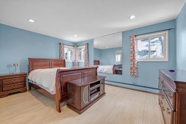 bedroom with a baseboard heating unit, recessed lighting, and light wood-style floors