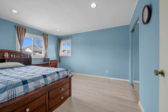 bedroom featuring recessed lighting, a closet, light wood-style flooring, and baseboards