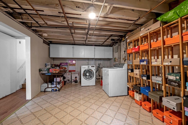 unfinished below grade area with light floors, a sink, and washer and dryer