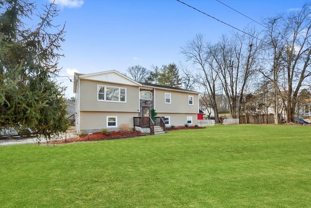 rear view of house featuring a lawn