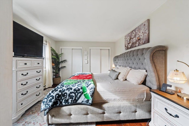 bedroom featuring multiple closets and hardwood / wood-style flooring