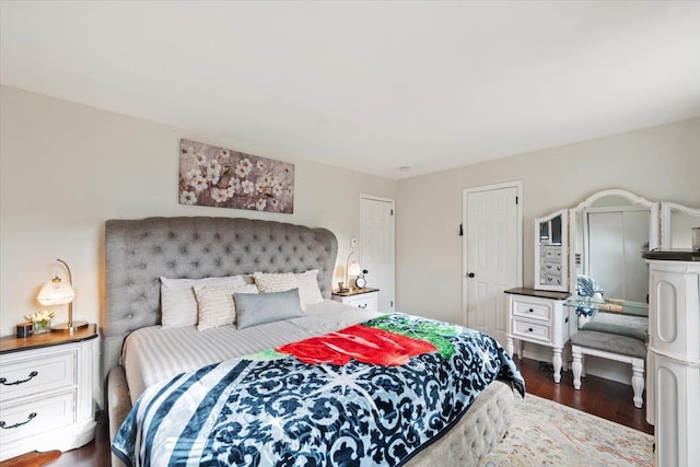 bedroom with dark wood-type flooring