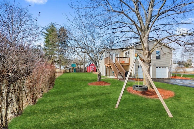 view of yard with a garage and a wooden deck