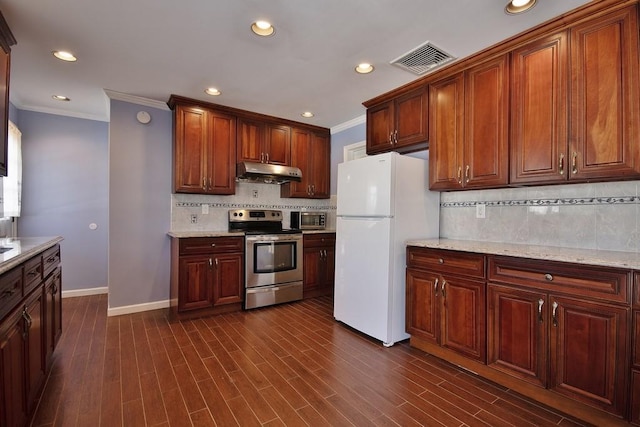 kitchen with light stone counters, dark hardwood / wood-style flooring, stainless steel range with electric cooktop, and white fridge