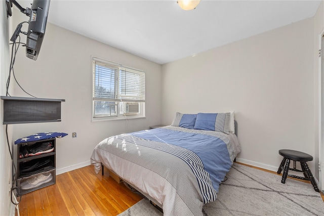 bedroom with hardwood / wood-style flooring and cooling unit