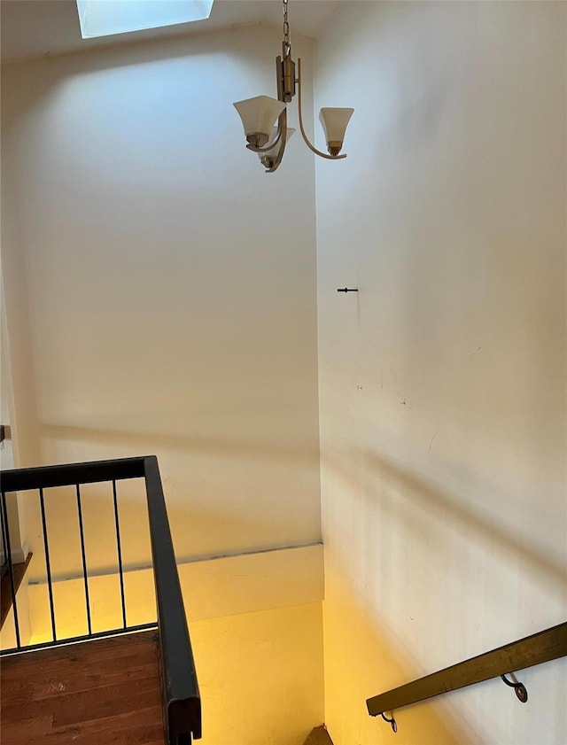 interior details featuring a skylight and an inviting chandelier