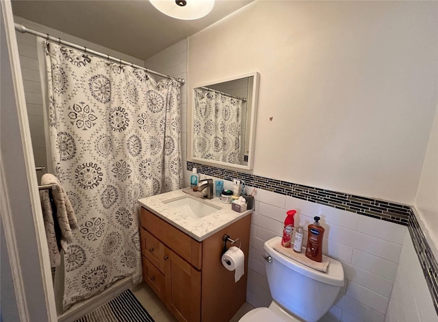 bathroom featuring tile patterned flooring, vanity, tile walls, toilet, and a shower with shower curtain