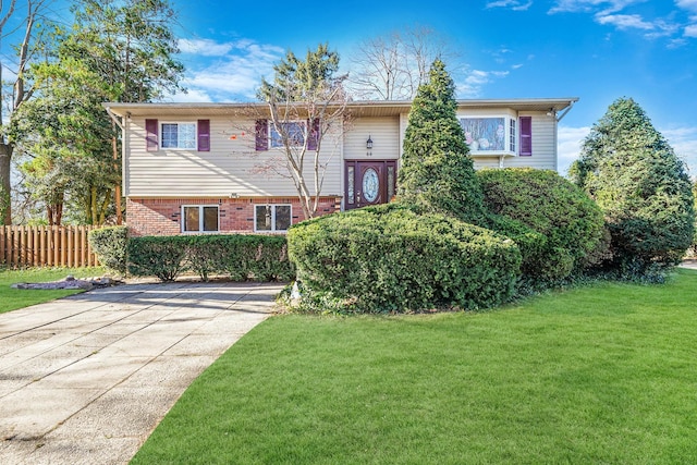 bi-level home with a front lawn