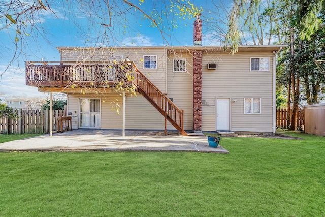 back of property featuring a wooden deck, a lawn, and a patio