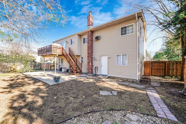 back of property featuring a deck and a patio area