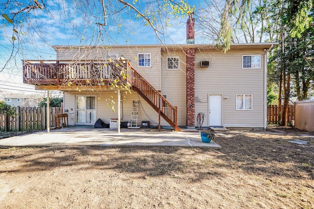 rear view of property with a deck and a patio