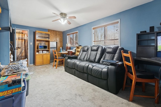 living room featuring ceiling fan and light colored carpet