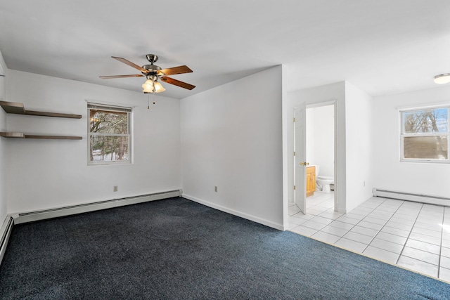 spare room featuring baseboard heating, ceiling fan, and light carpet