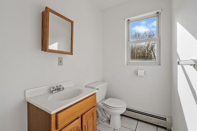 bathroom with vanity, a baseboard heating unit, tile patterned flooring, and toilet