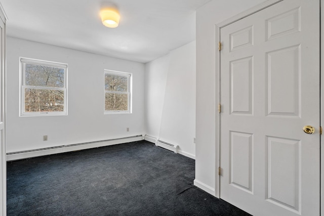 carpeted empty room featuring a baseboard radiator