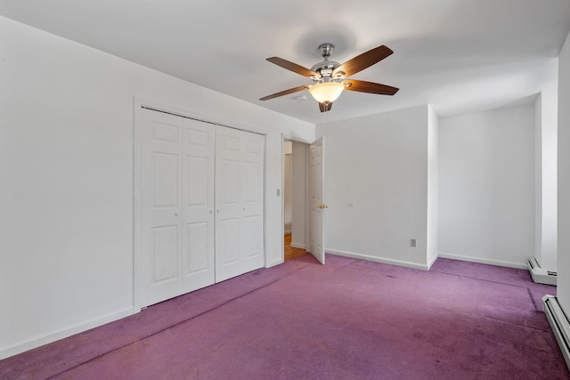 unfurnished bedroom with ceiling fan, a closet, baseboard heating, and carpet