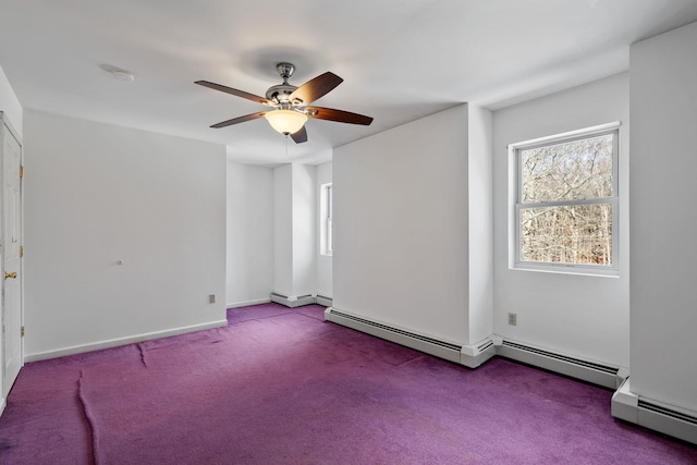 empty room featuring a baseboard heating unit, ceiling fan, and carpet