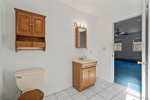 bathroom featuring a baseboard radiator, vanity, toilet, and tile patterned flooring