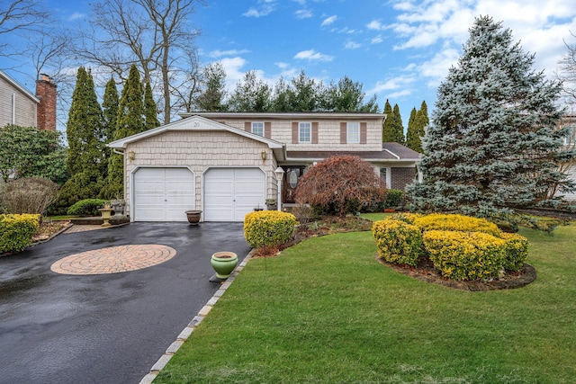 view of front property with a garage and a front yard