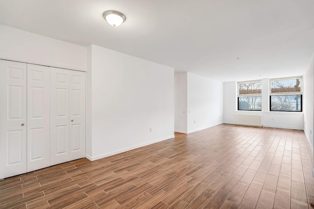 interior space with baseboards and wood finished floors