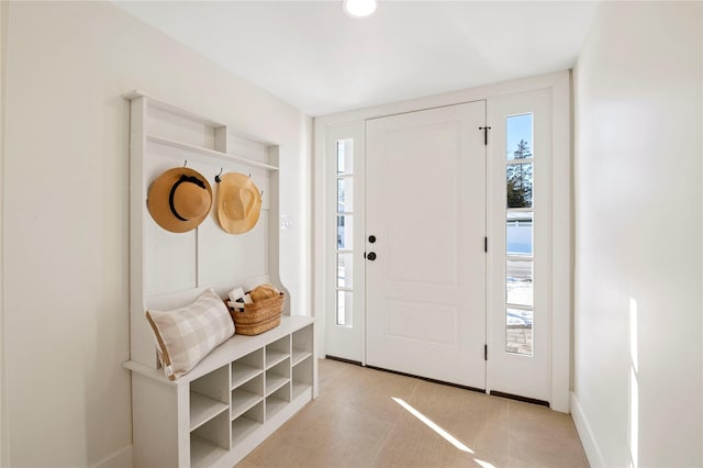 mudroom with plenty of natural light and light tile patterned flooring