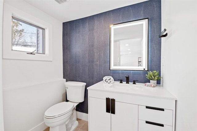 bathroom with toilet, tile patterned flooring, and vanity