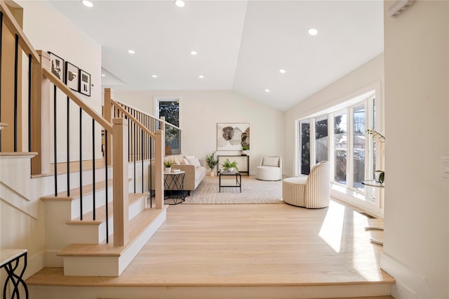 interior space featuring light hardwood / wood-style floors and vaulted ceiling