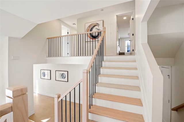 staircase with lofted ceiling