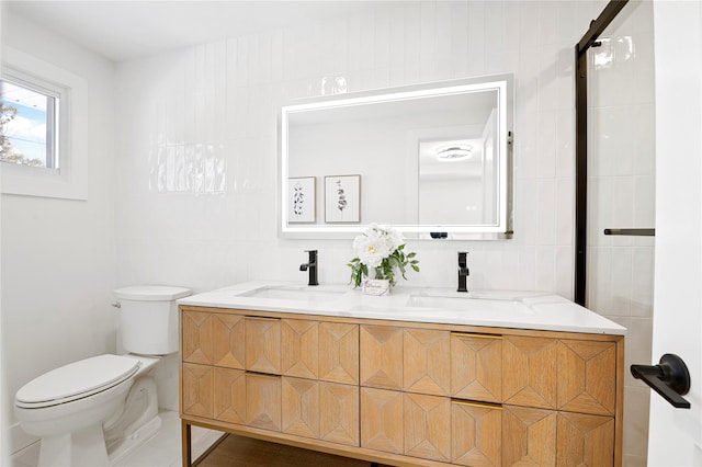 bathroom with backsplash, toilet, vanity, and tile walls