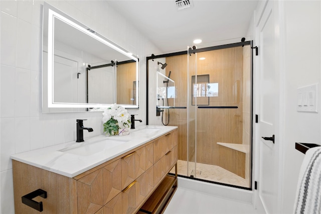 bathroom featuring vanity and a shower with door