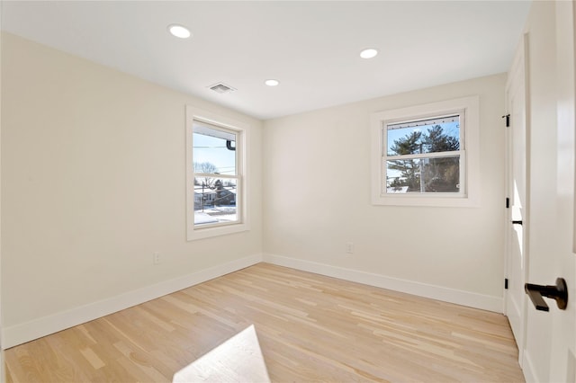 empty room featuring light hardwood / wood-style flooring and plenty of natural light