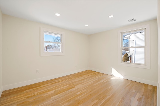 empty room with light hardwood / wood-style flooring