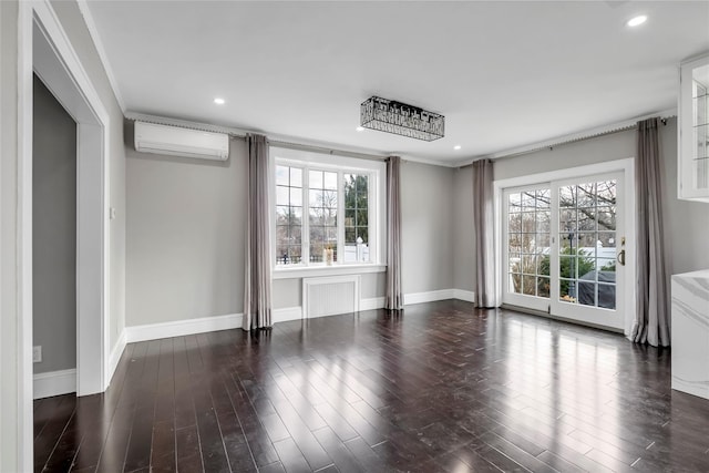 spare room featuring crown molding, a wall mounted AC, and dark hardwood / wood-style floors