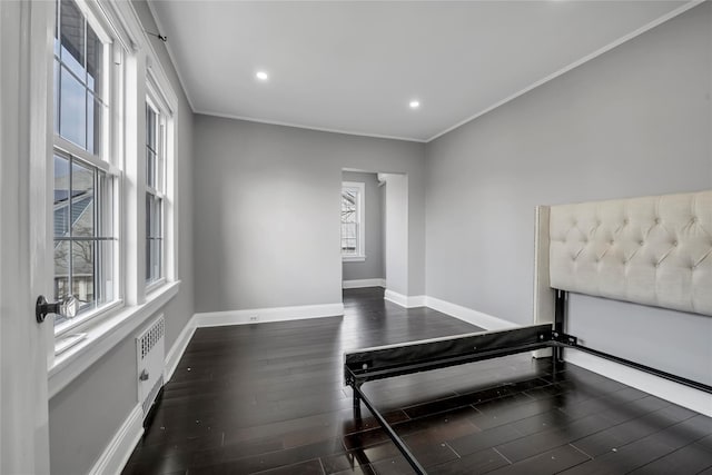 interior space with dark hardwood / wood-style flooring and crown molding