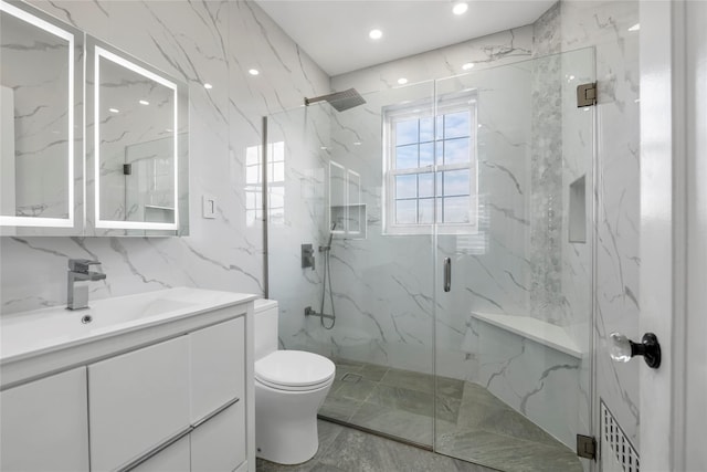 bathroom featuring toilet, vanity, and walk in shower