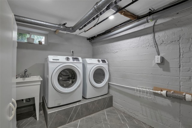 clothes washing area featuring washer and dryer