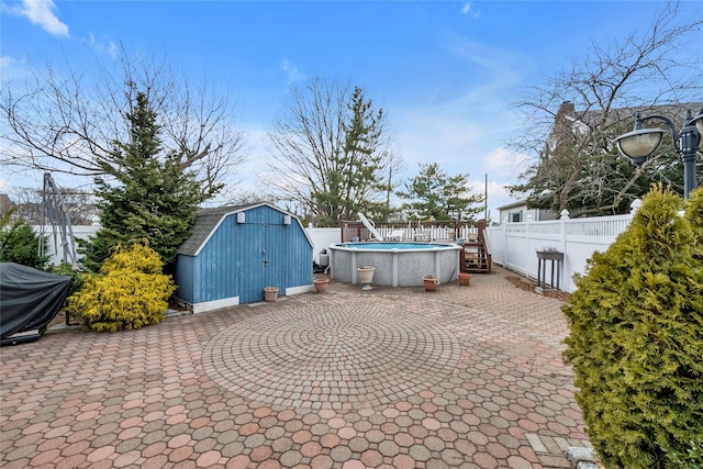 view of patio featuring a shed, a grill, and a fenced in pool